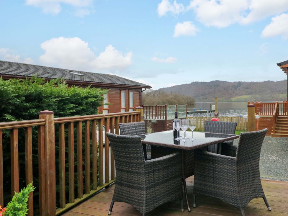 An outdoor seating area with a table and chairs at Waters Edge Lodge in Windermere