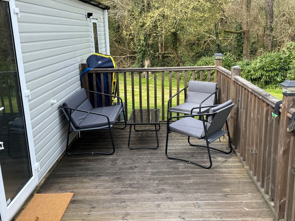 A seating area with chairs and a table on a deck at N5 in Ilfracombe