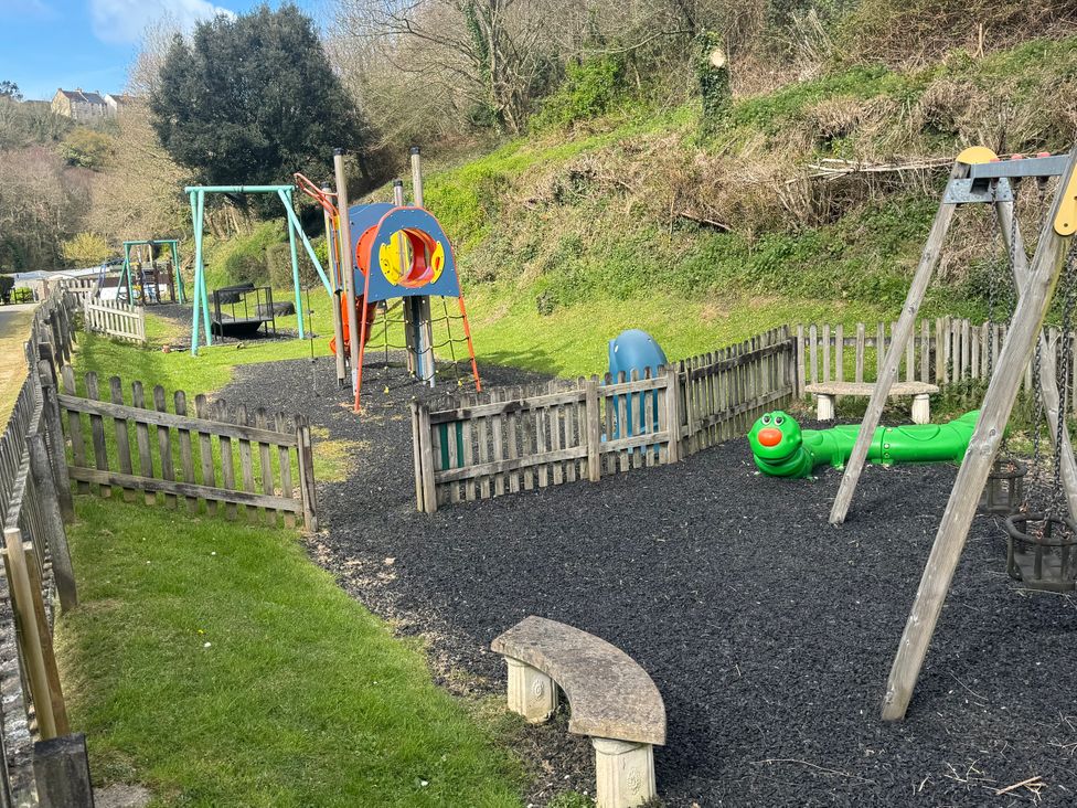 A playground with swings and a slide at N5 Ilfracombe