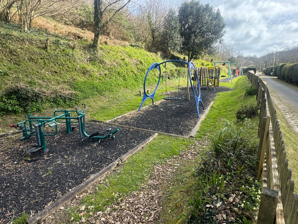 A playground with swings and exercise equipment at N5 Ilfracombe