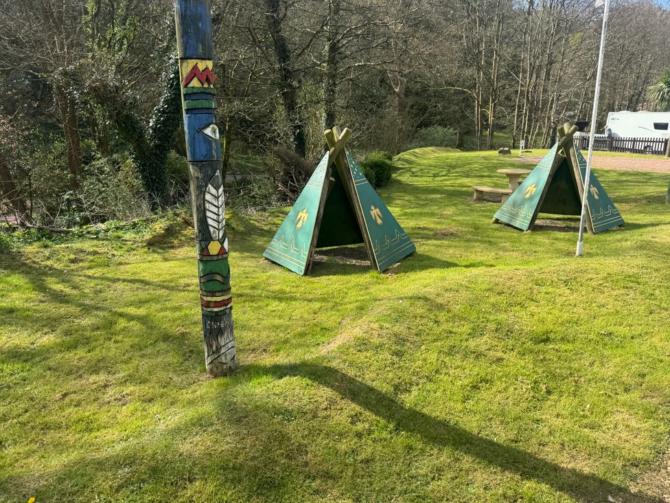 An outdoor area with tents and a totem pole at N5 Ilfracombe