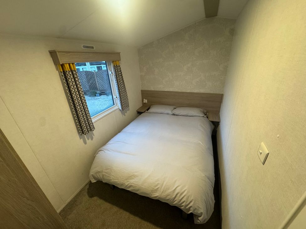 A bedroom with a bed and window at N5 Ilfracombe