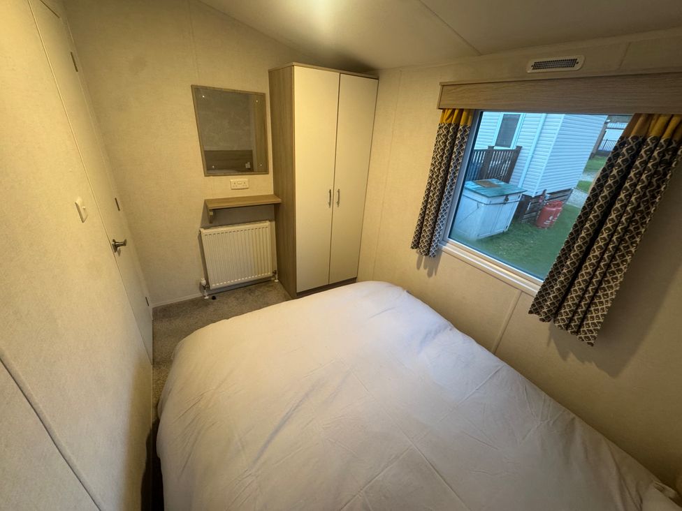 A bedroom with a bed and wardrobe at N5 Ilfracombe