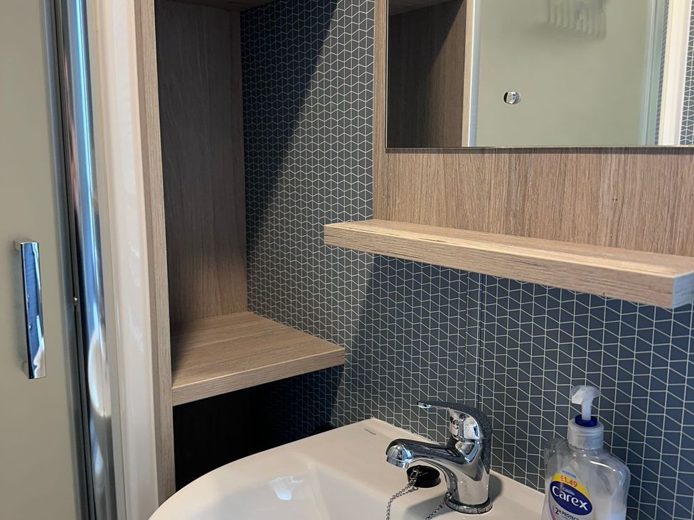 A bathroom with a sink and a mirror at N5 in Ilfracombe