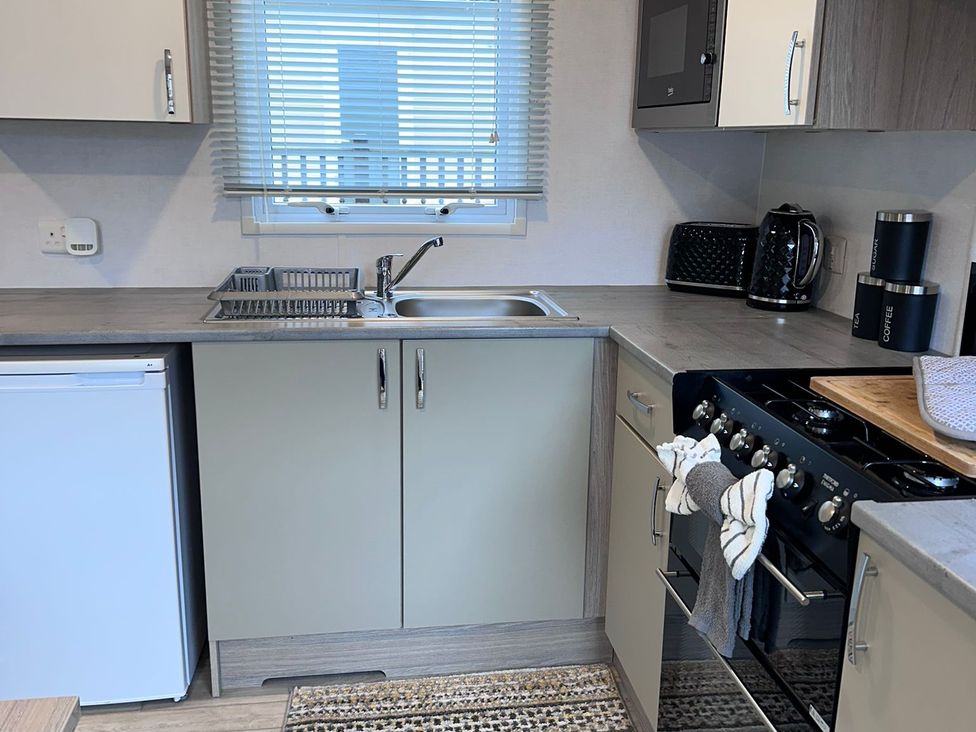 A kitchen with a sink and appliances at N5 in Ilfracombe