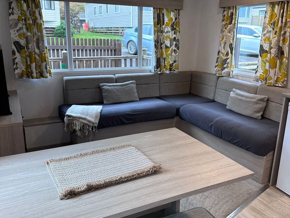 A living room with a sofa and table at N5 in Ilfracombe