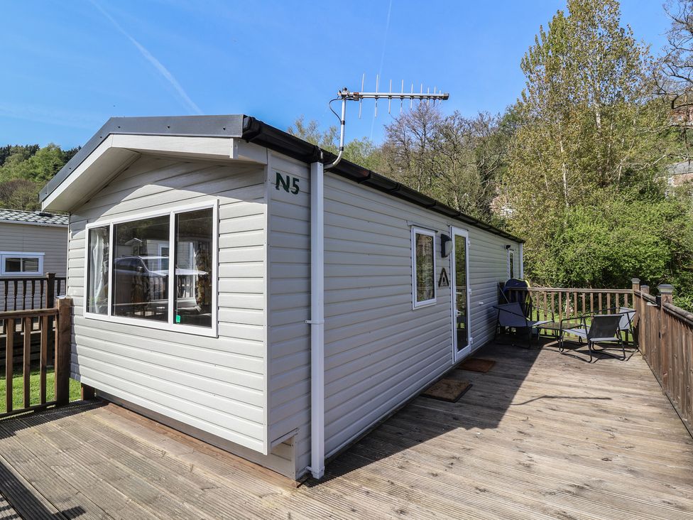 A cabin with a deck and chairs at N5 Ilfracombe