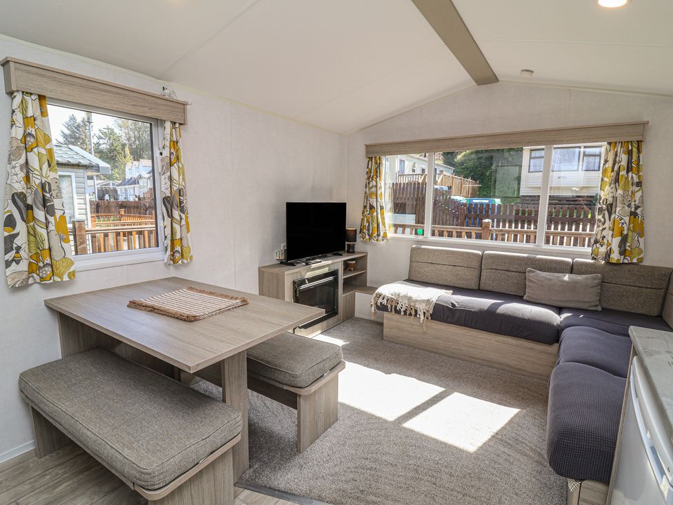 A living room with a sofa and dining table at N5 Ilfracombe