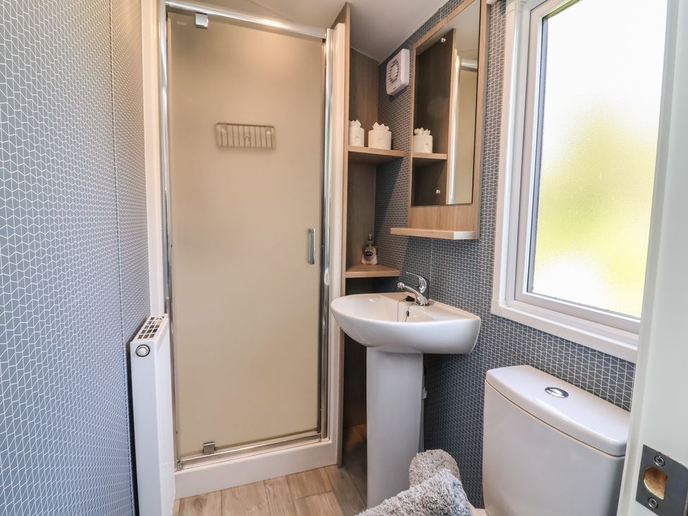 A bathroom with a shower, sink, and toilet at N5 in Ilfracombe