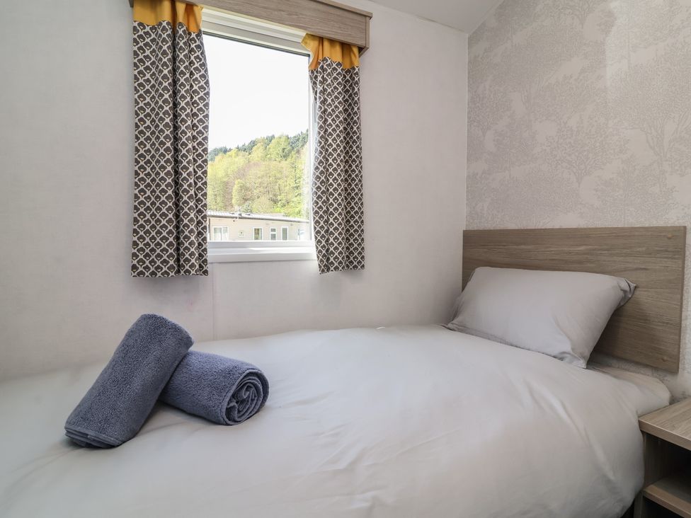 A bedroom with a bed and towels at N5 in Ilfracombe