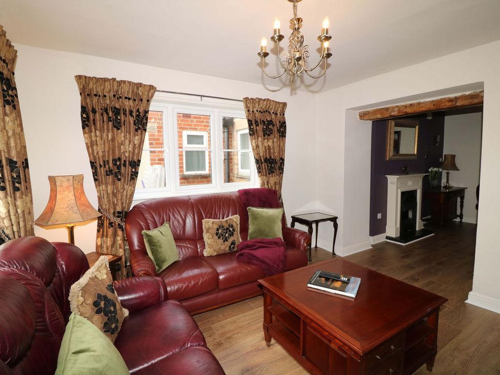 A living room with a brown sofa and a coffee table at The Annexe in Belper