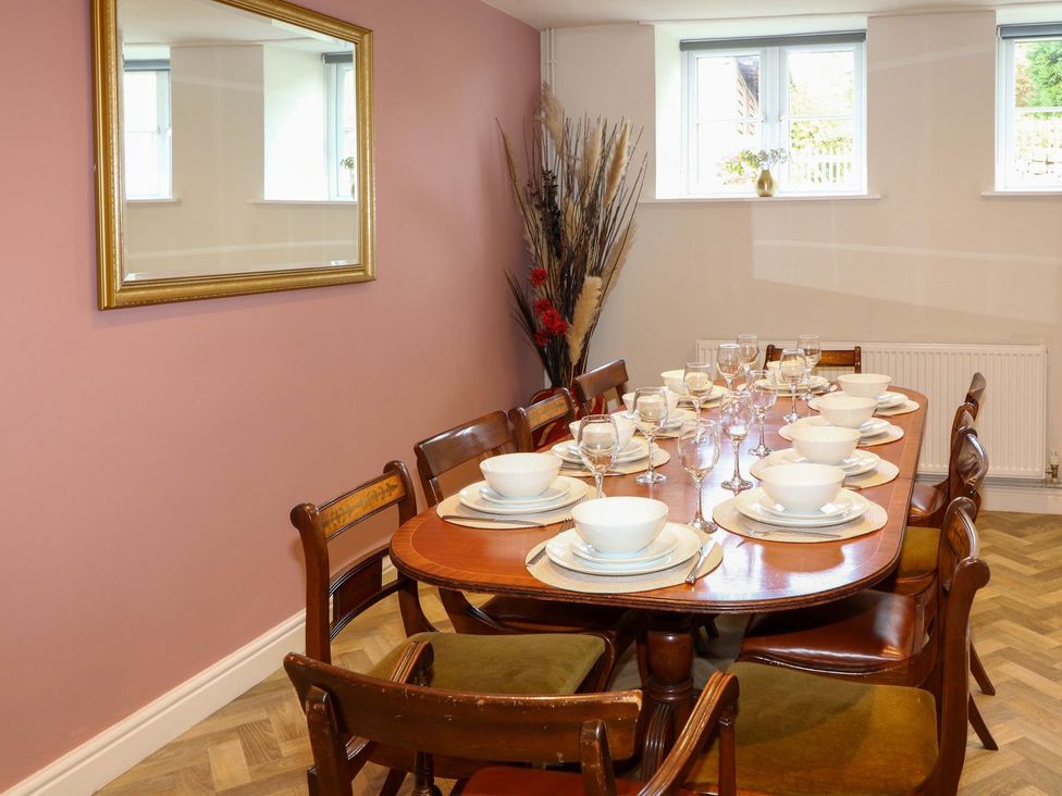 A dining room with a table set for a meal at The Annexe in Belper