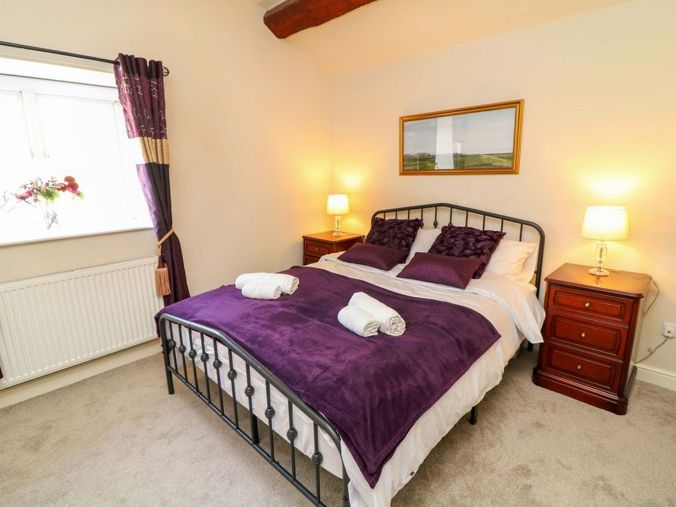 A bedroom with a bed and bedside tables at The Annexe in Belper
