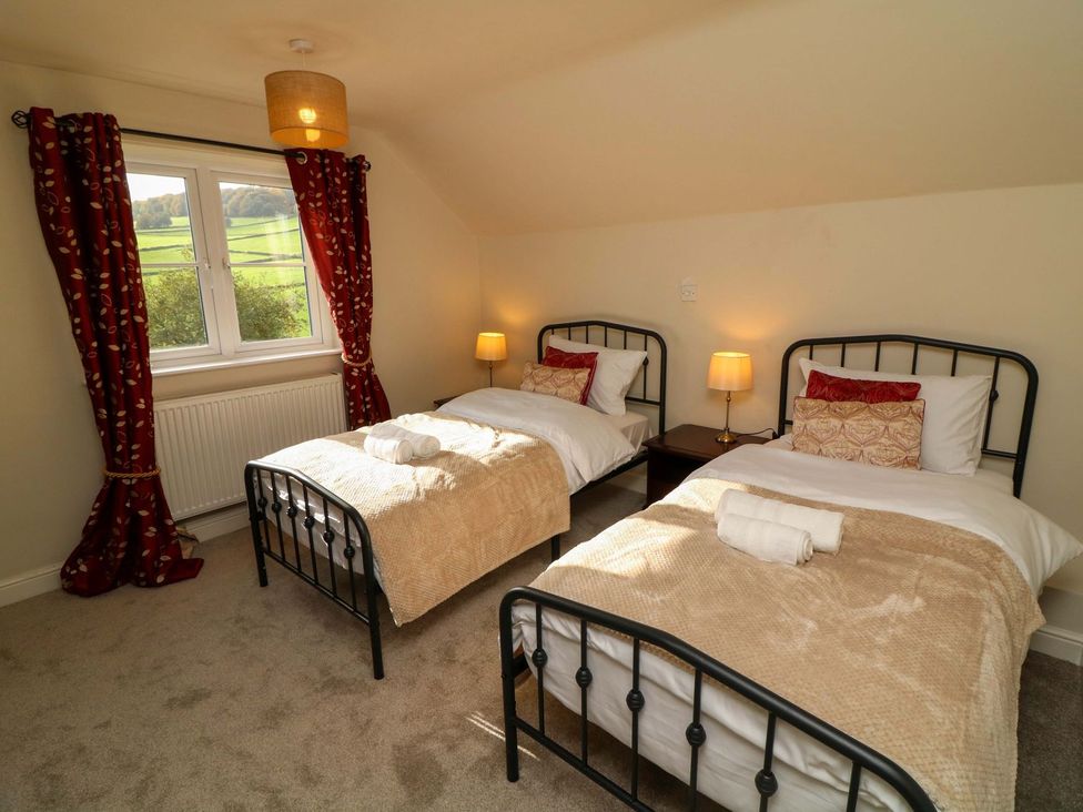 A bedroom with two beds and a window at The Annexe in Belper