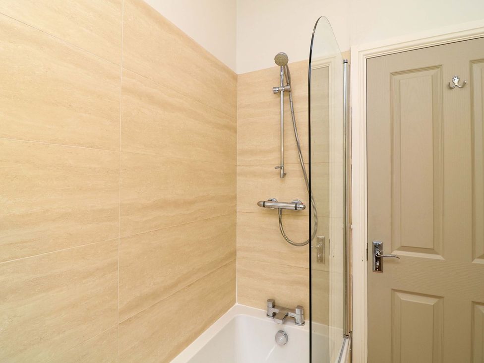 A bathroom with a bathtub and shower at The Annexe in Belper