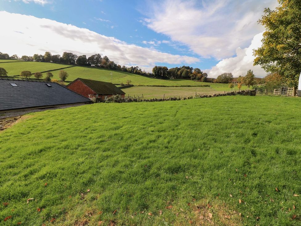 A field with grass and buildings in the distance at The Annexe in Belper