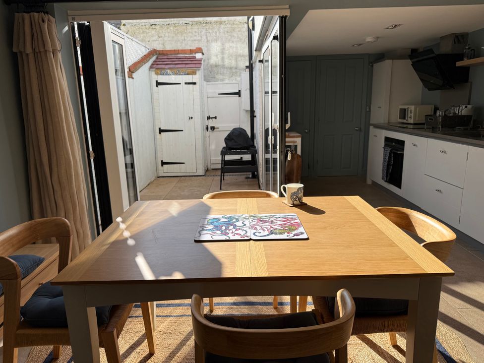 A dining room with a table and chairs at York Cottage in Southwold