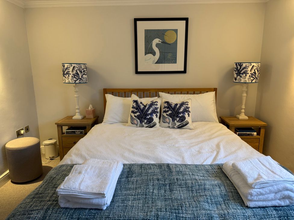 A bedroom with a bed and bedside tables at York Cottage Southwold