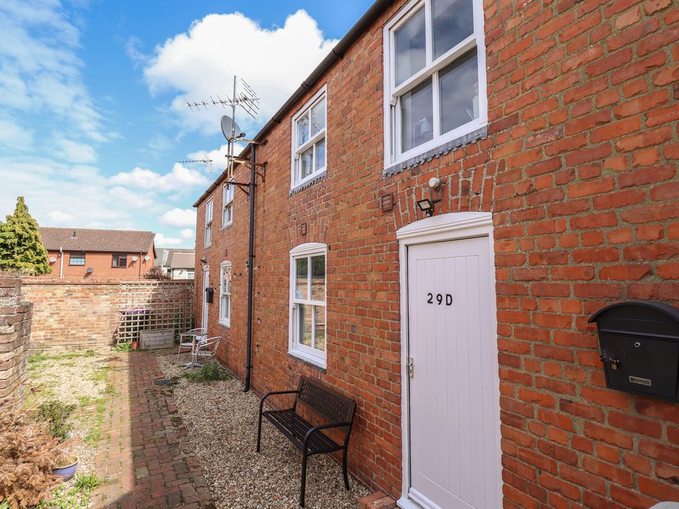 An outdoor area with a brick wall and a door at 29B High Street in Spilsby