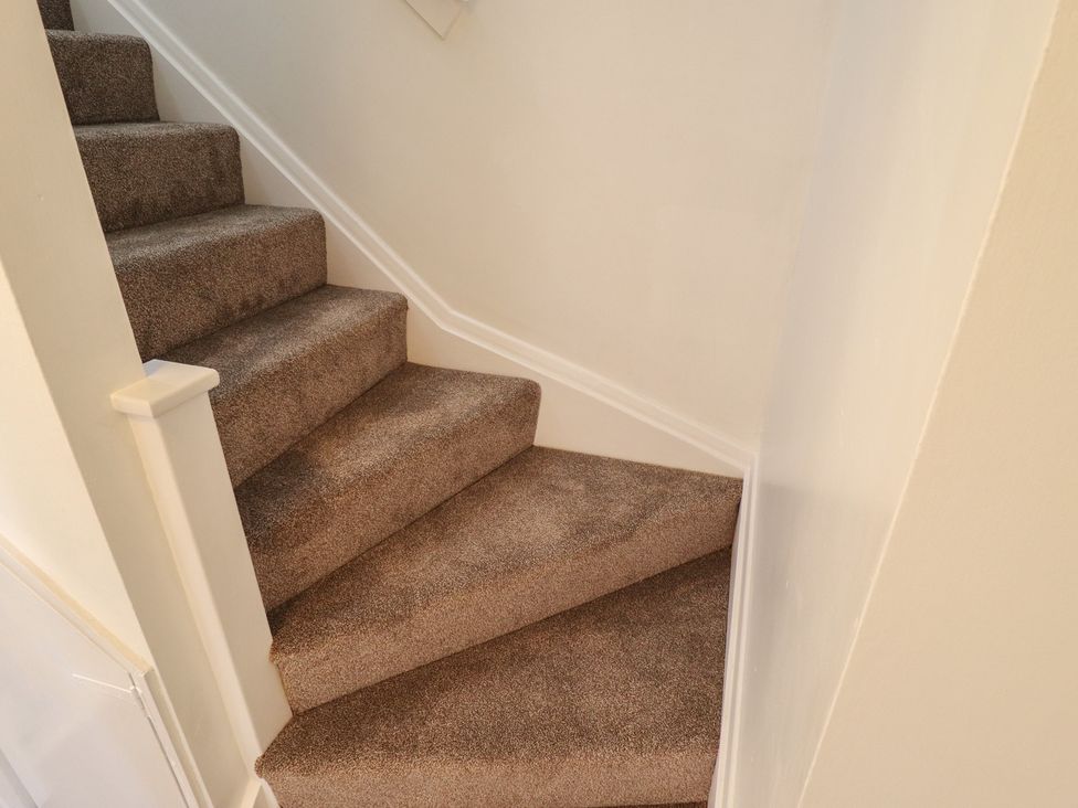 A staircase with carpet and handrail at 29B High Street in Spilsby