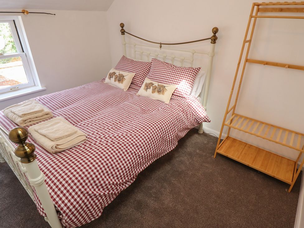 A bedroom with a bed and shelves at 29B High Street Spilsby