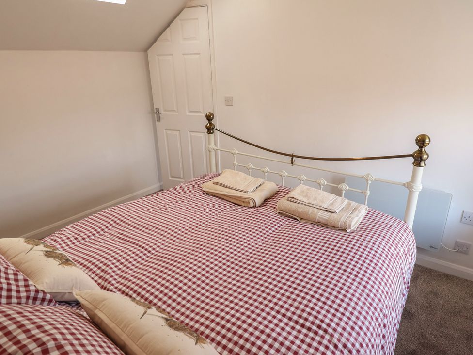 A bedroom with a bed and towels at 29B High Street, Spilsby