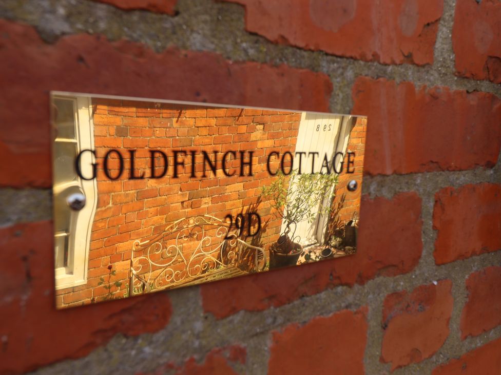 A plaque on a brick wall at Goldfinch Cottage in Spilsby