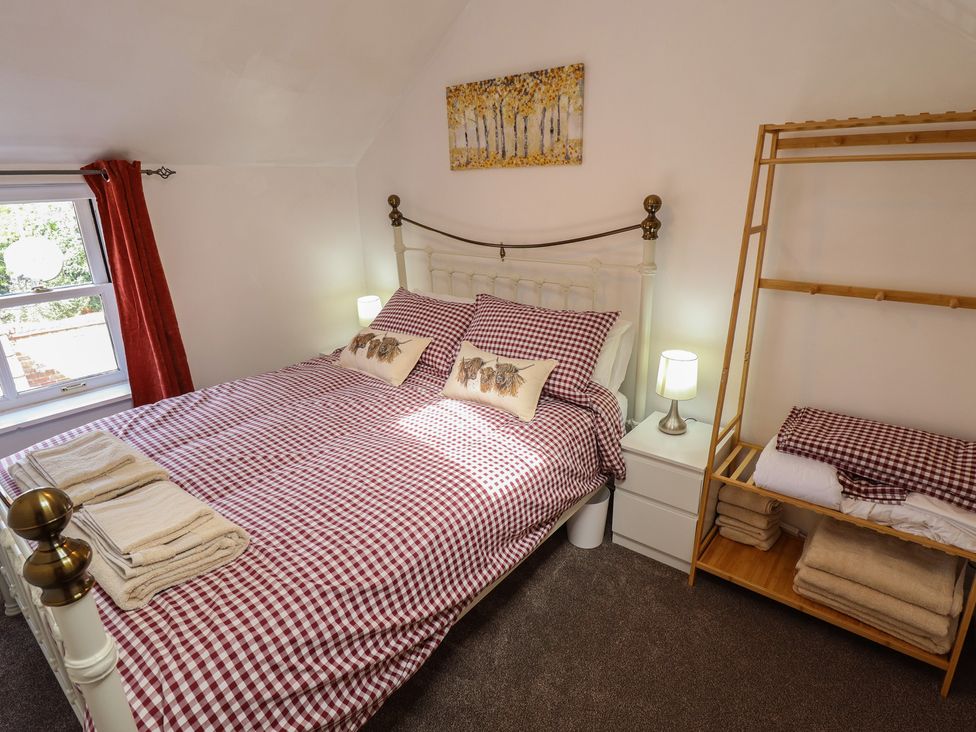 A bedroom with a bed and shelving at Goldfinch in Spilsby