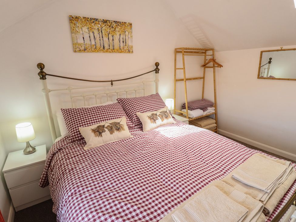 A bedroom with a bed and lamp at Goldfinch in Spilsby