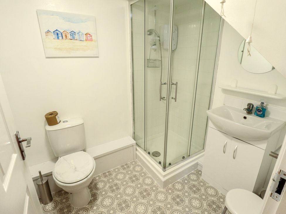 A bathroom with a shower, toilet, and sink at Goldfinch in Spilsby