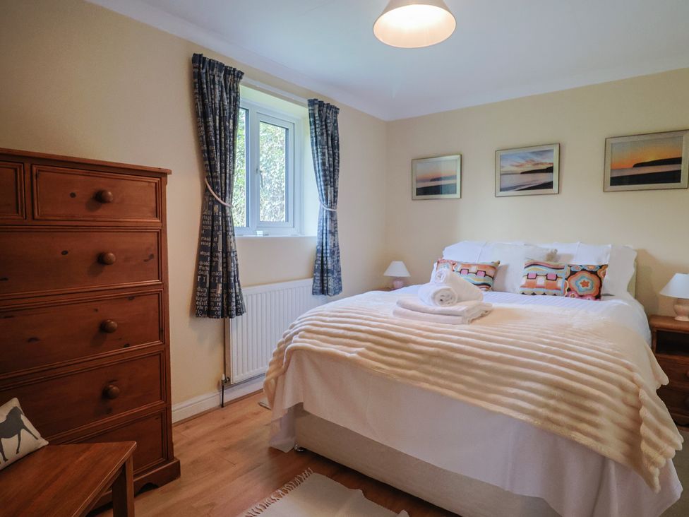 A bedroom with a bed and dresser at Regenna in Seaton