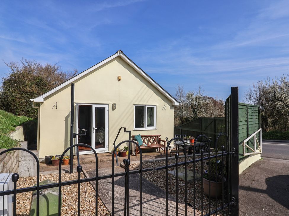 A house with a pathway and a bench at Regenna Seaton