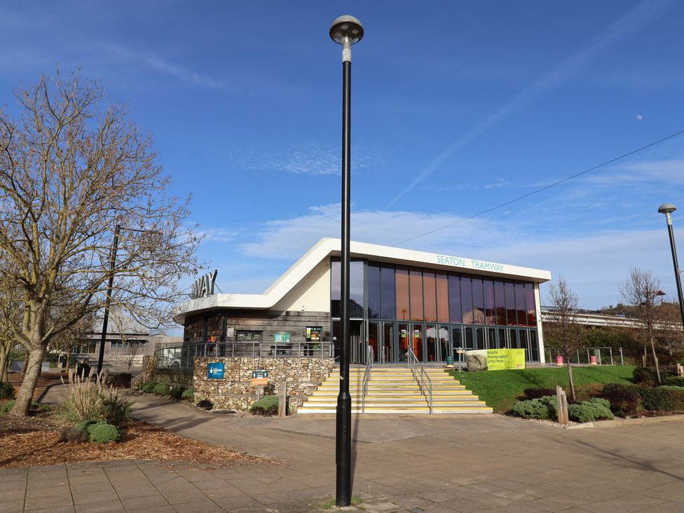 A building with glass windows and entrance steps at Seaton Tramway in Seaton