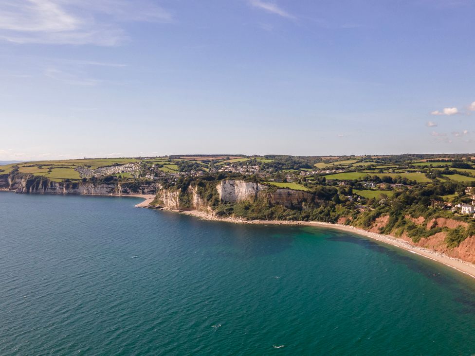 A coastal view with cliffs and beach at Regenna in Seaton