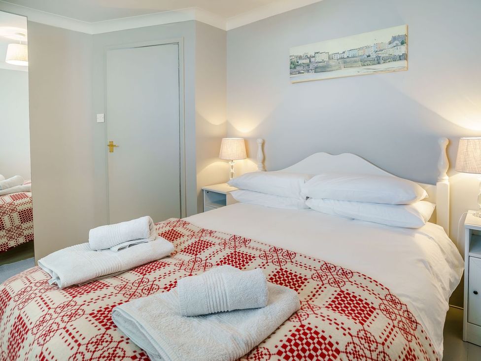 A bedroom with a bed and towels at Brewery Cottage 