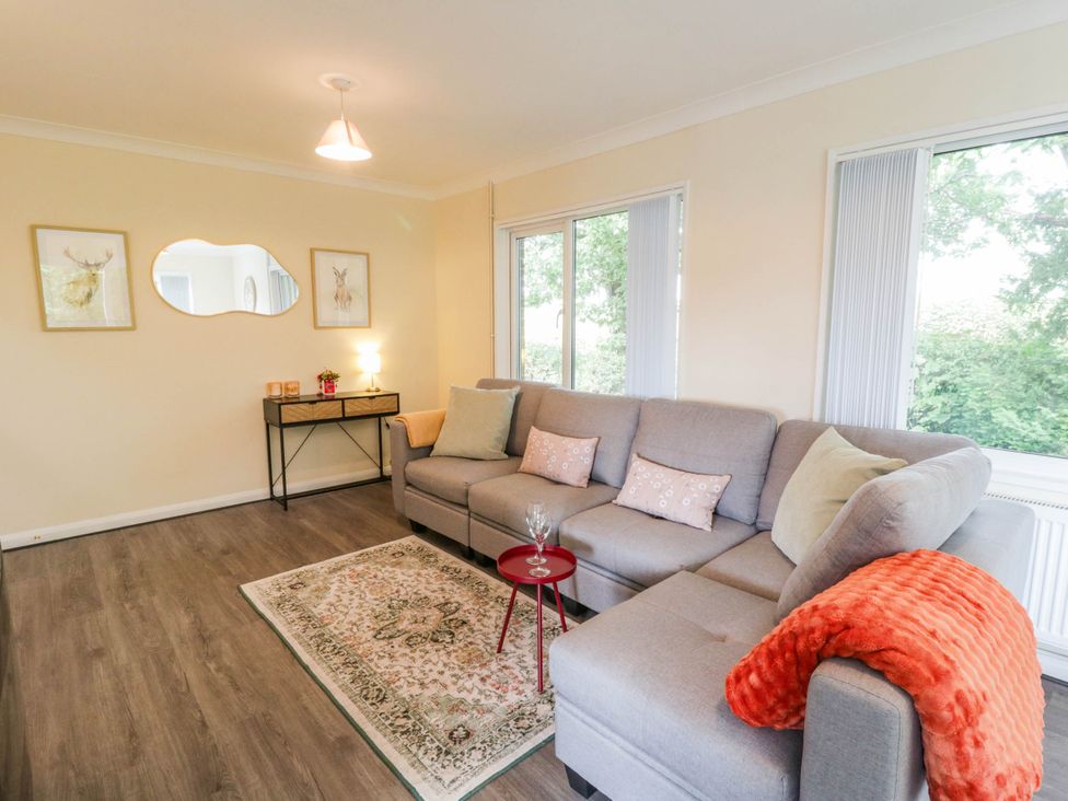A living room with a sofa and table at The Croft in Llandrindod Wells