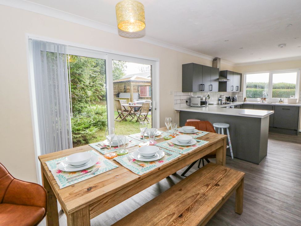 A dining room with a table set for meals at The Croft in Llandrindod Wells
