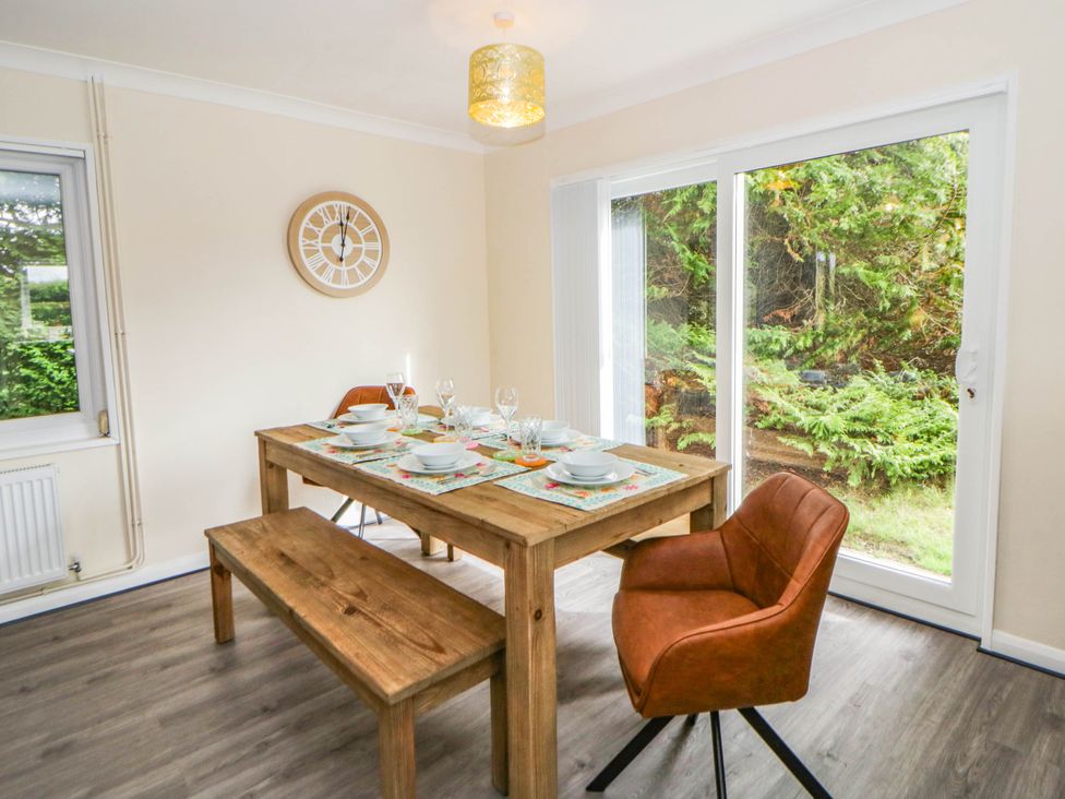 A dining room with a wooden table and chairs at The Croft in Llandrindod Wells