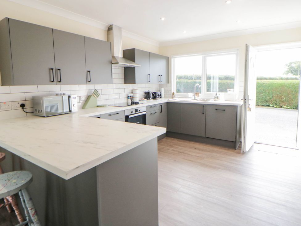 A kitchen with cabinets and appliances at The Croft in Llandrindod Wells