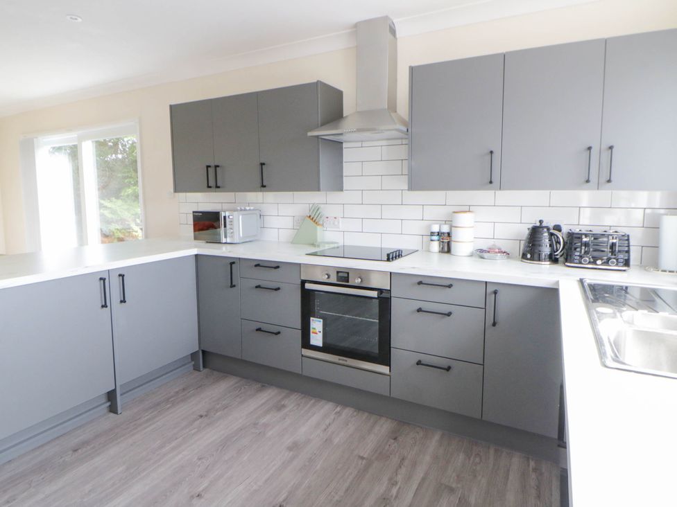 A kitchen with grey cabinets and appliances at The Croft in Llandrindod Wells