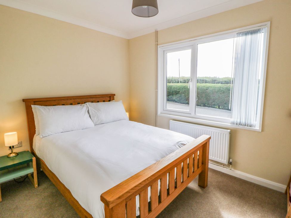 A bedroom with a bed and a window at The Croft in Llandrindod Wells
