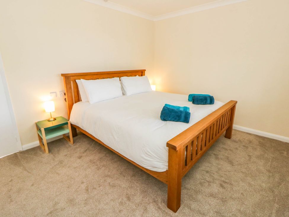 A bedroom with a bed and bedside table at The Croft in Llandrindod Wells
