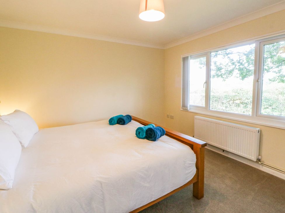 A bedroom with a bed and towels on it at The Croft in Llandrindod Wells