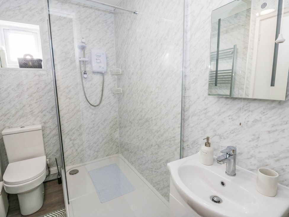 A bathroom with a shower, toilet, and sink at The Croft in Llandrindod Wells