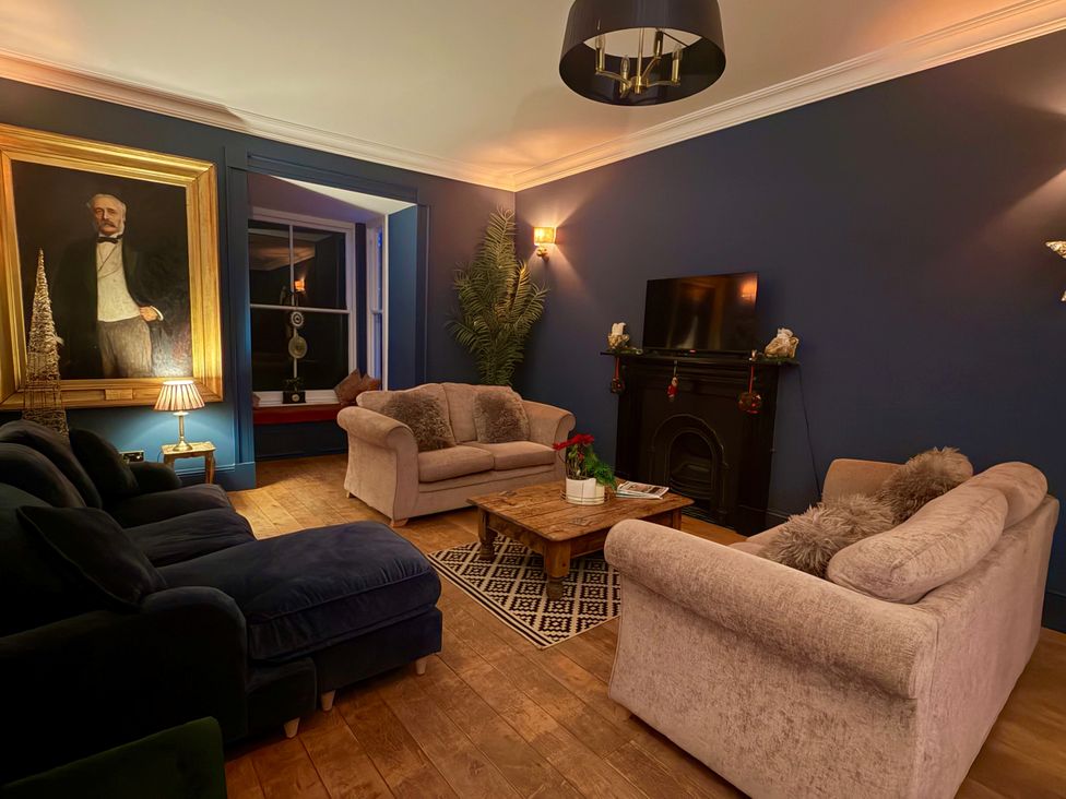 A living room with a sofa and coffee table at Picton House near St Clears