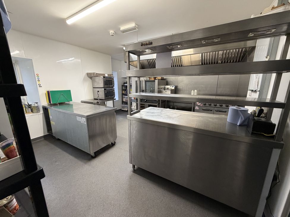 A kitchen with stainless steel appliances and counters at Picton House near St Clears