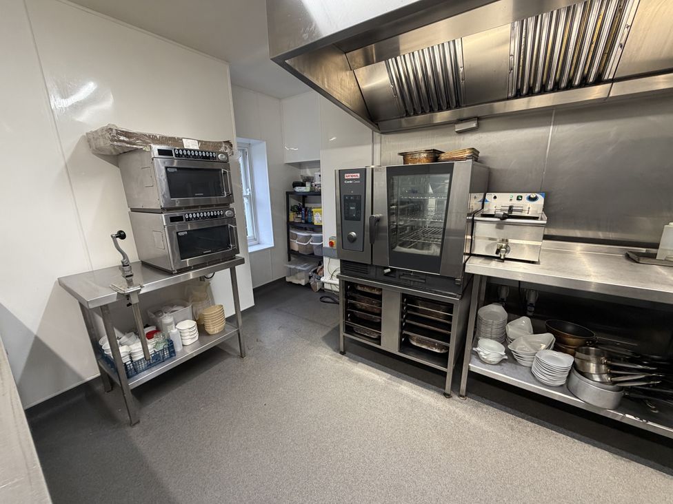 A kitchen with ovens and shelves at Picton House near St Clears