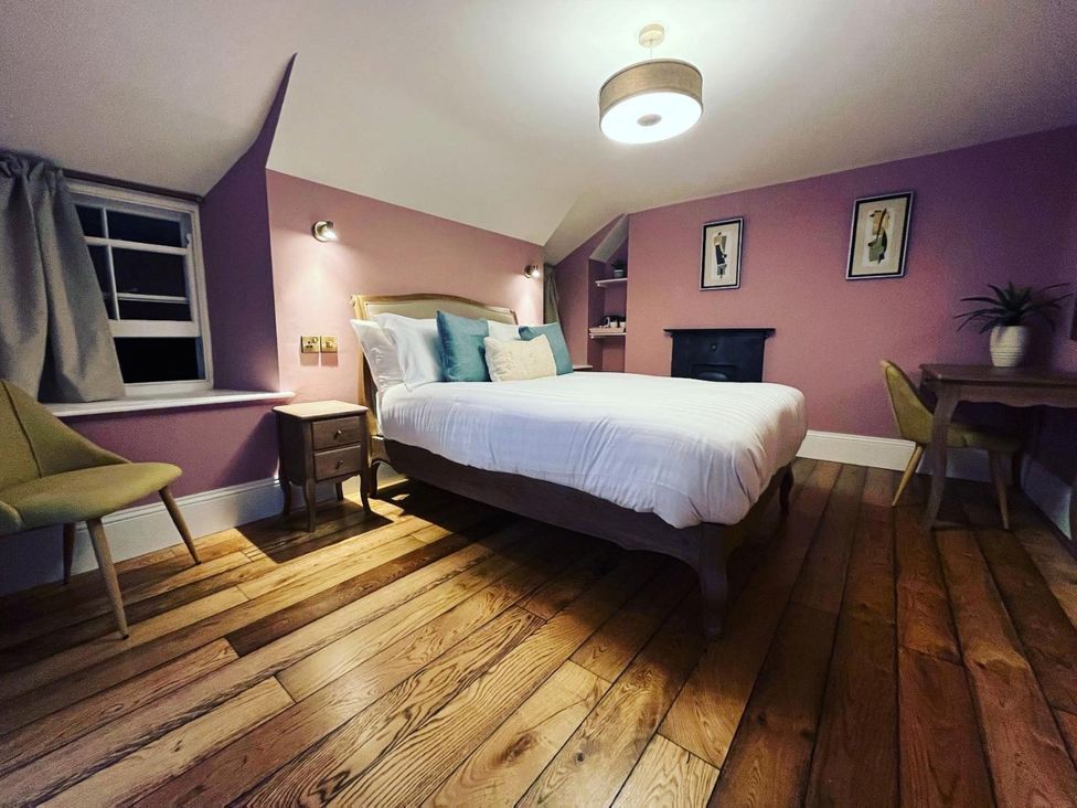 A bedroom with a bed and desk at Picton House near St Clears
