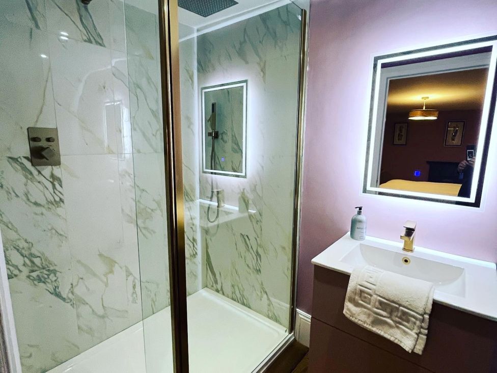 A bathroom with a shower and sink at Picton House near St Clears