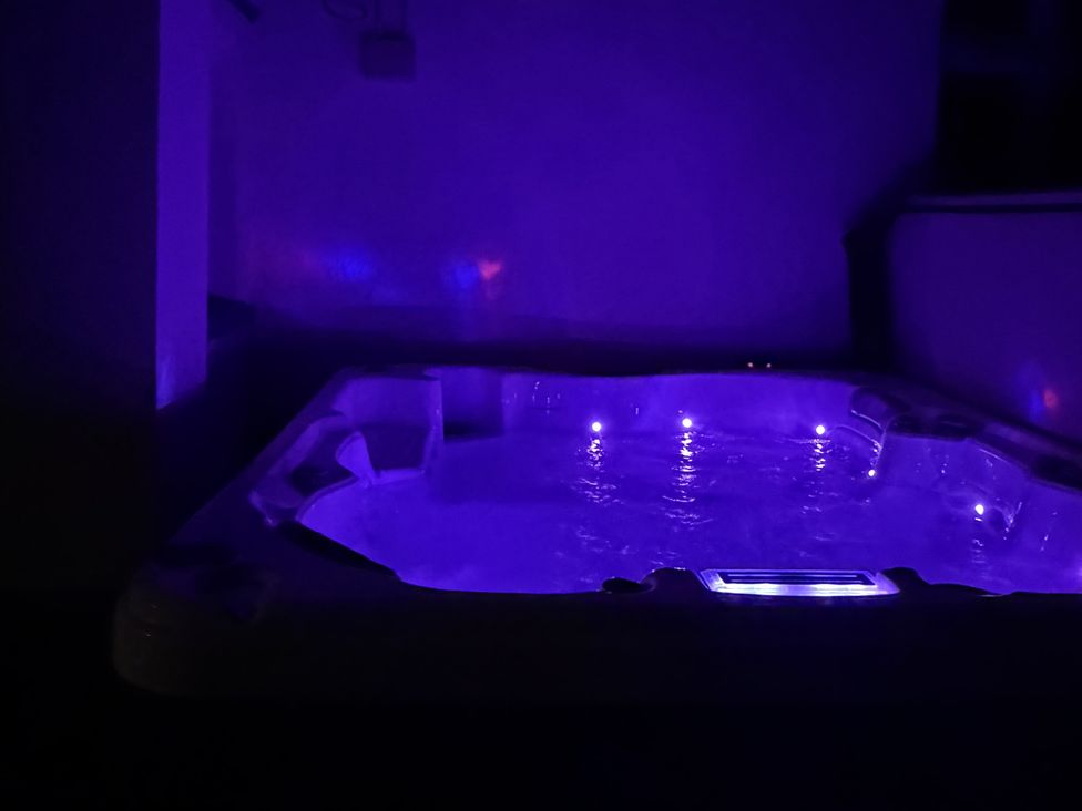 A hot tub with LED lights in an indoor bathroom at Picton House near St Clears